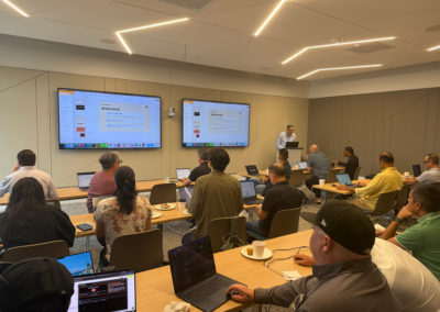 Attendees working on hands-on exercises during the Claude Code workshop at the Irvine venue