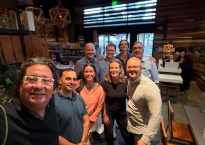 AllCode team members and workshop attendees networking at the bar during the post-workshop happy hour